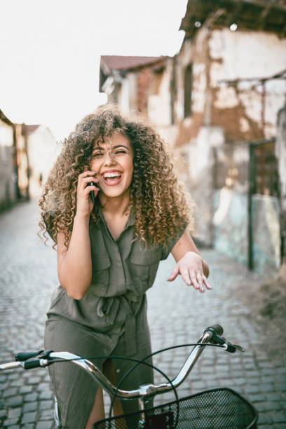 istock Cute Female Cyclist Talking On Phone 1189398274