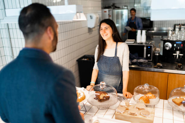 istock Cafeteria employee giving support to a customer 1189400692