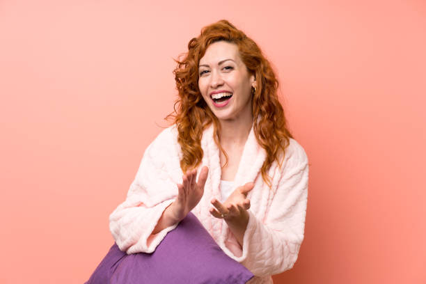 istock Redhead woman in dressing gown applauding 1189401664