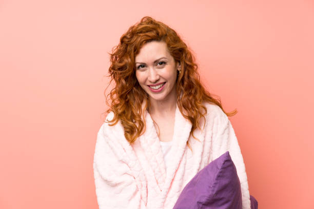 istock Redhead woman in dressing gown laughing 1189401766