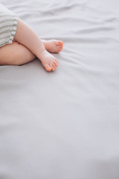 istock little baby feet bed delicate textile conceptual 1189402918