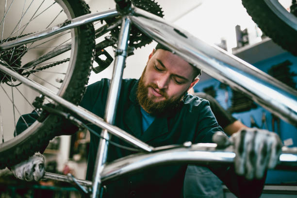 istock Handsome Male Mechanic Devoting His Full Attention On Bike Repairs 1189402919