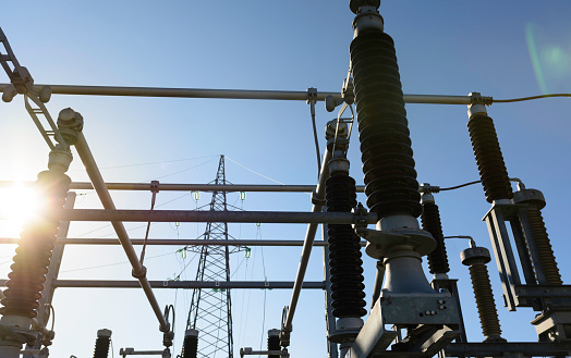 Power station on a sunset, close up of a high voltage transformer in power substation.