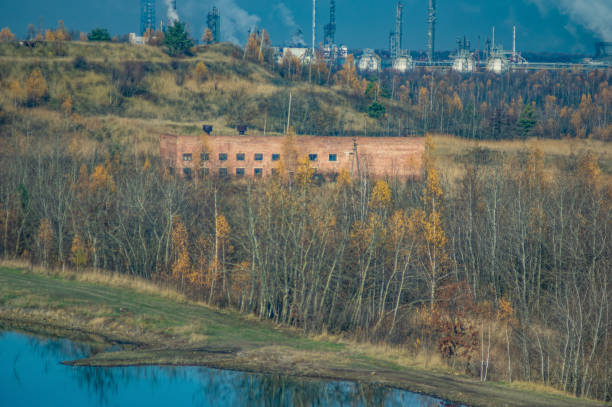 istock Factories in an industrial area among the forest 1189406610
