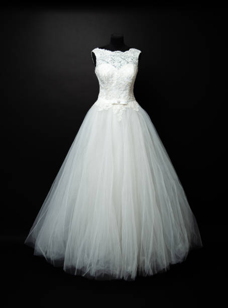 white wedding dress on black background in studio
