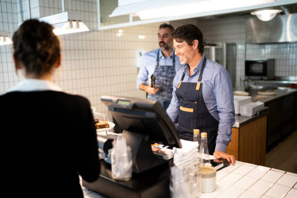 istock Cafeteria employee giving support to a customer 1189410287