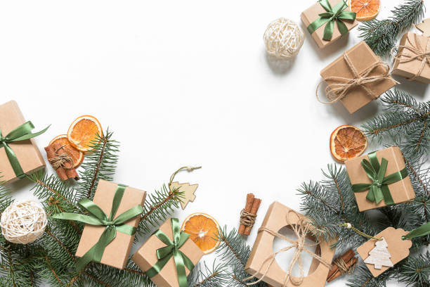 istock Christmas zero waste, eco friendly packaging. Festive Christmas composition packs gifts in kraft paper on a light table, eco Winter weekend concept, eco decor 1189415891