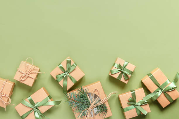 istock Christmas zero waste, eco friendly packaging. Festive Christmas composition packs gifts in kraft paper on a green background, eco Winter weekend concept, eco decor 1189415968