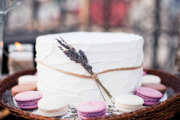 istock white cake with cream, macaroons and lavender flowers 1189418204