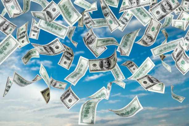 istock One hundred dollar bills falling out of the sky 118941851