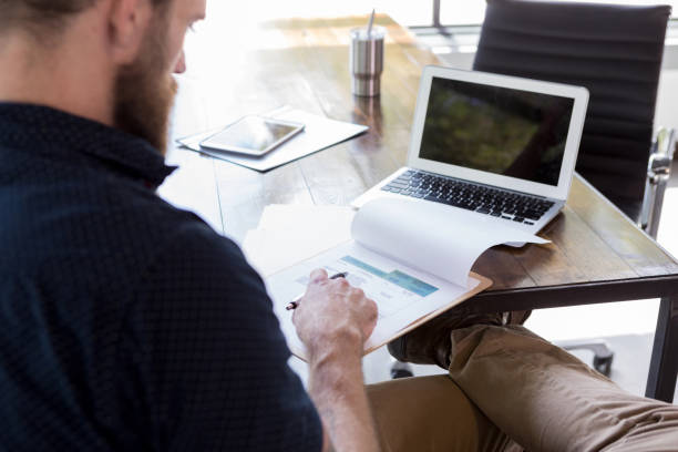 istock Businessman reviews invoice 1189419325
