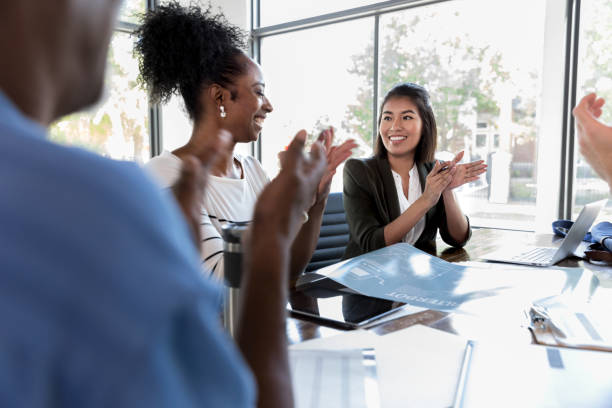 istock Businesspeople applauding colleague 1189419352