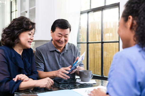 istock Senior man points out information on brochure to wife 1189419433