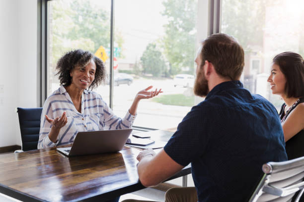 istock Financial advisor meets with young couple 1189419716