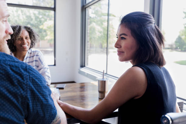istock Woman smiles at husband during counseling session 1189419737