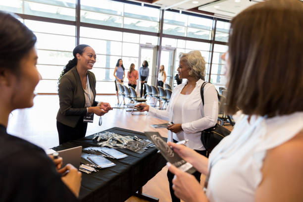 istock Helpful businesswoman assists conference attendees 1189420934