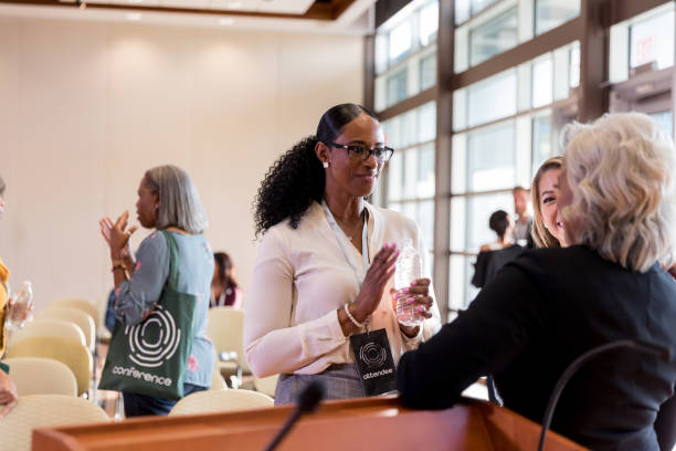 istock Excited businesswomen talks with conference speaker 1189420949