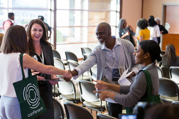 istock Business people greet one another at conference 1189420970