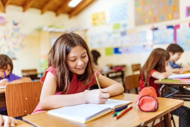 istock Elementary education in Latin America - school girl writing in her notebook 1189422552