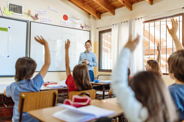 istock Elementary education in Latin America - teacher sharing knowledge with school children 1189423612