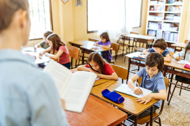 istock Elementary education in Latin America - teacher sharing knowledge with school children 1189424423
