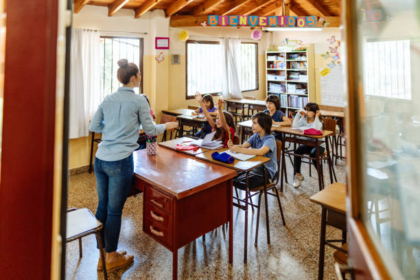 istock Elementary education in Latin America - teacher sharing knowledge with school children 1189424572