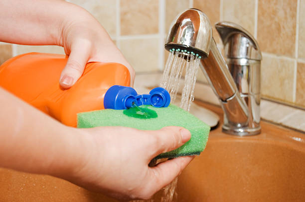 istock The woman pours a washing-up liquid 118943172