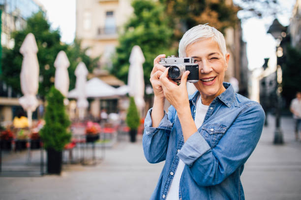 istock Older woman taking a photo 1189436025