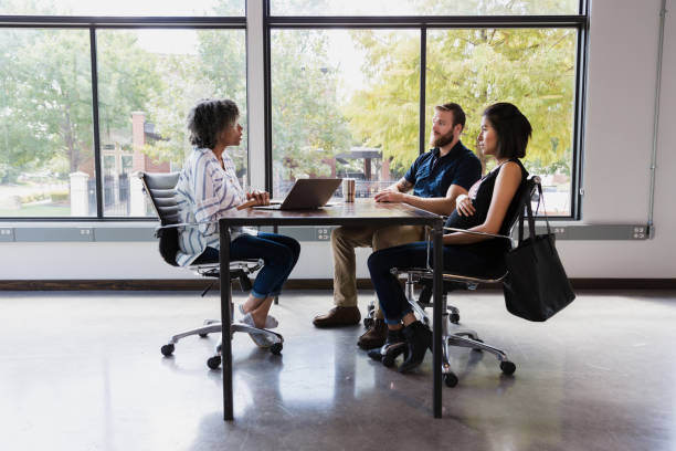istock Attentive expectant couple meet with female ob/gyn 1189436342