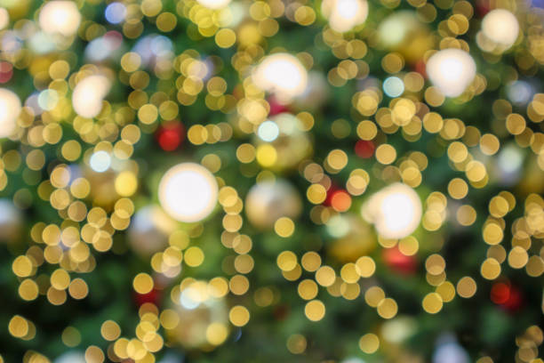 istock Abstract christmas holiday with festive gold bokeh light on tree blurred background 1189446149
