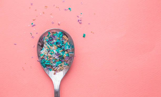 Environmental pollution and water microplastic. Micro plastic with spoon Environmental pollution and water microplastic. Micro plastic with spoon. microplastic stock pictures, royalty-free photos & images