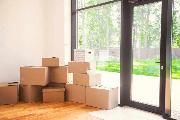 istock Moving day, cardboard boxes in new apartment 1189450400