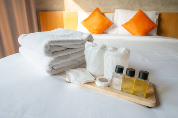 istock Set of hotel amenities (such as towels, shampoo, soap etc) on the bed. 1189455982