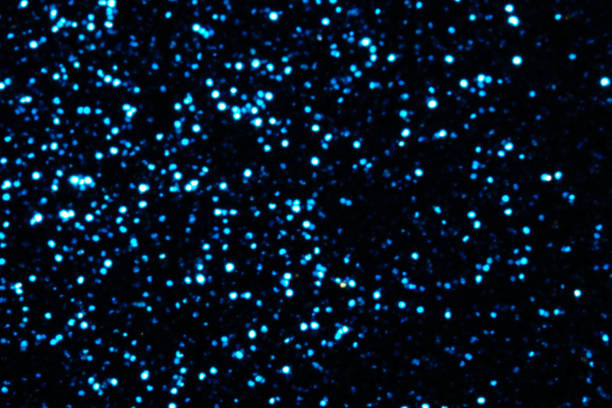 istock blue Sparkling Lights Festive background with texture. Abstract Christmas twinkled bright bokeh defocused and Falling stars. Winter Card or invitation 1189469123