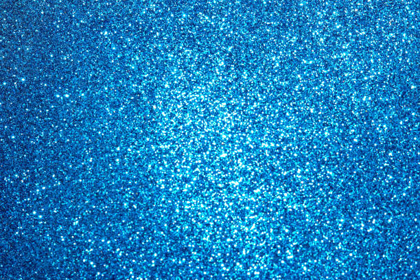 istock blue Sparkling Lights Festive background with texture. Abstract Christmas twinkled bright bokeh defocused and Falling stars. Winter Card or invitation 1189469144