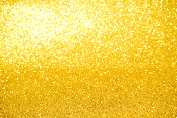 istock gold Sparkling Lights Festive background with texture. Abstract Christmas twinkled bright bokeh defocused and Falling stars. Winter Card or invitation 1189469187