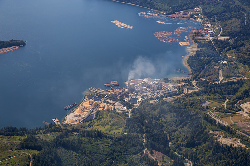 Aerial View of an Industrial Site in Howe Sound during a sunny summer morning. Located in Port Mellon near Gibsons, Sunshine Coast, BC, Canada.