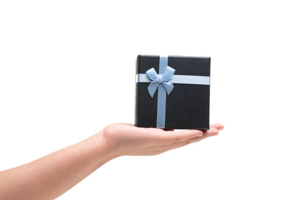 istock Girl Hand Hold Gift box with blue ribbon isoalted on white 1189469944