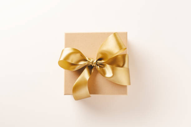istock Gift with golden ribbon on golden background 1189476802