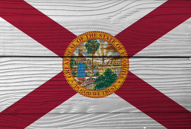 Florida flag color painted on Fiber cement sheet wall background, the states of America. A red saltire on a white background, with the state seal. stock photo