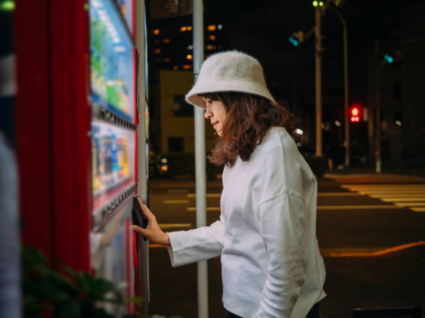 istock Asian woman selecting some drink at vending machine 1189482909