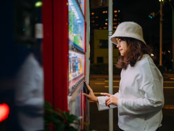 istock Asian woman paying with smartphone to vending machine. 1189482943