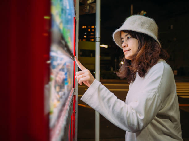 istock Asian woman paying with smartphone to vending machine. 1189482953
