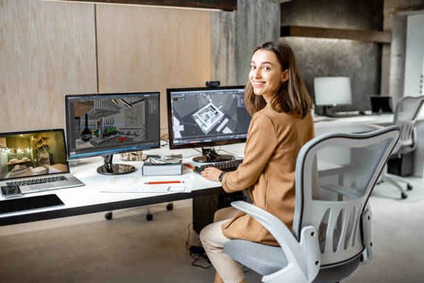 Young inteiror designer working in the office Portrait of a young creative office employee making interior design, 3d modeling on the computer while sitting at the modern office of architectural firm architect stock pictures, royalty-free photos & images