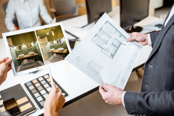 Close-up on blueprints with an architectural project in the office Creative office employees working on some architectural project, holding plans and interior renderings, close-up on the blueprints interior designer stock pictures, royalty-free photos & images