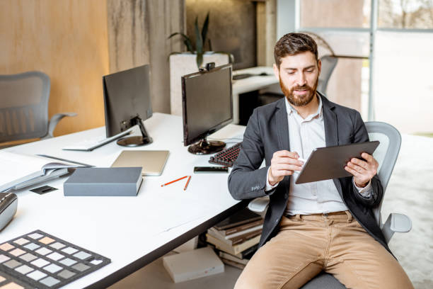 istock Man working on the digital tablet in the office 1189488241