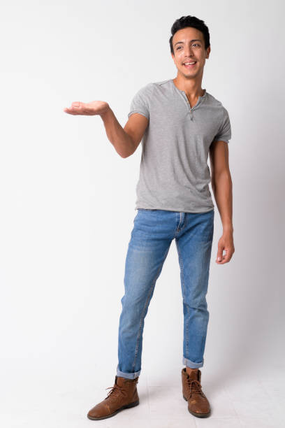 istock Full body shot of happy Hispanic man thinking while showing something 1189488330