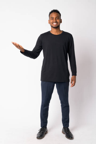 istock Full body shot of happy young handsome African man showing something 1189488564