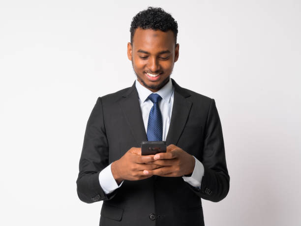 istock Happy young handsome African businessman using phone 1189488647
