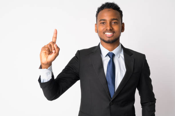 istock Happy young handsome African businessman pointing up 1189488678